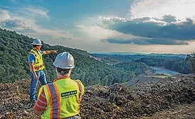 construction workers overlooking the land